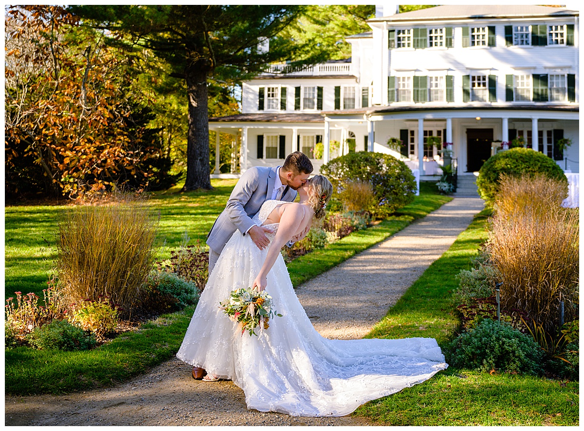 wedding couple kissing in front of mansion at Glen Magna danvers Massachusetts
