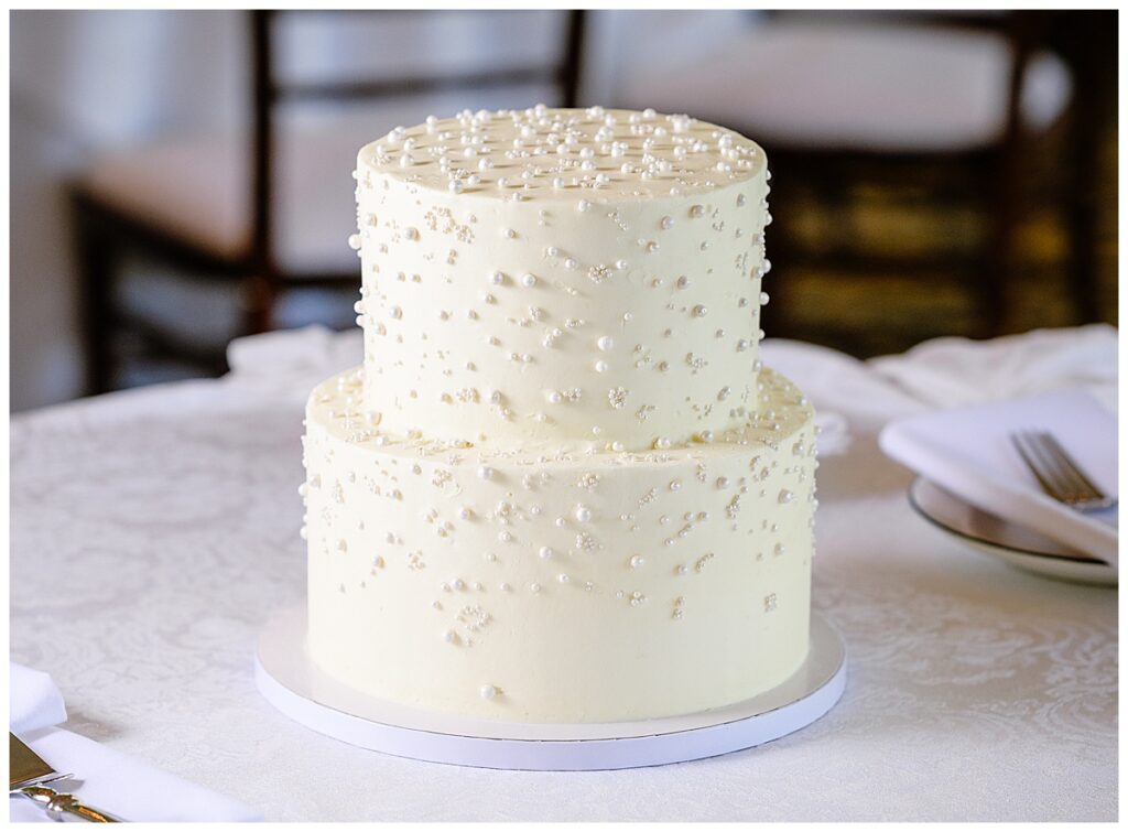 modern white wedding cake with white pearls