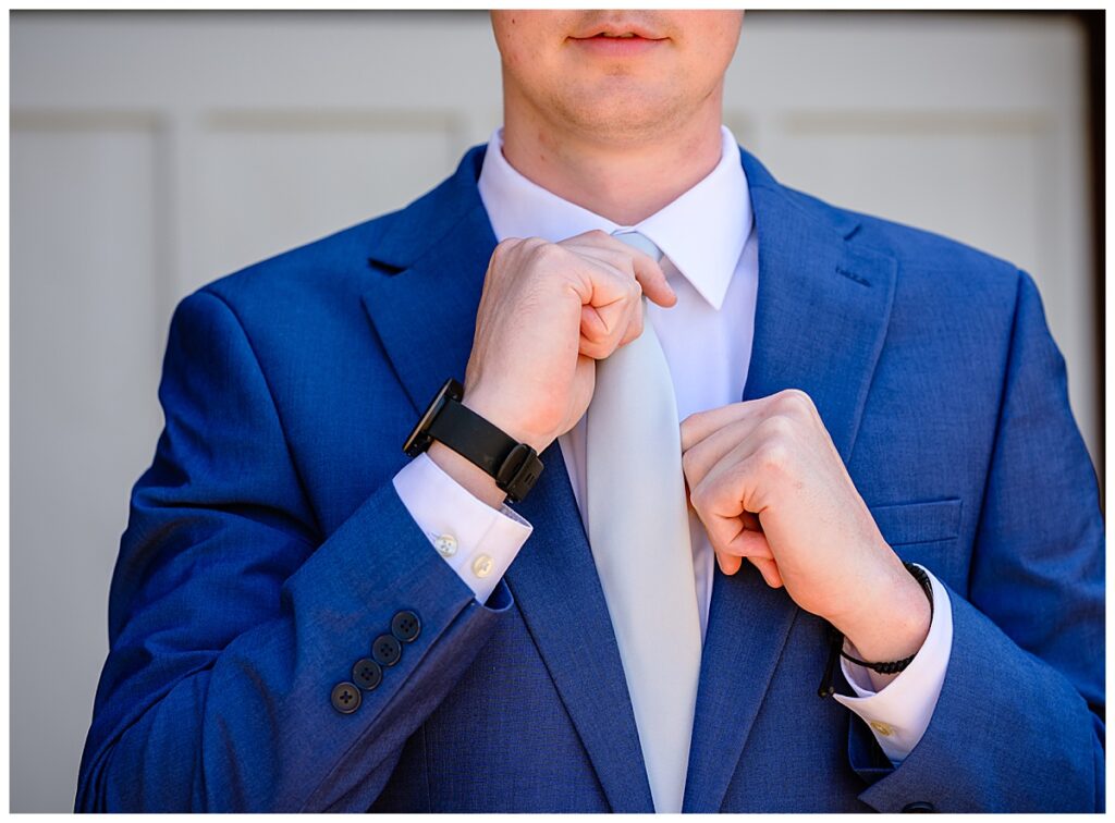 groom adjusting tie