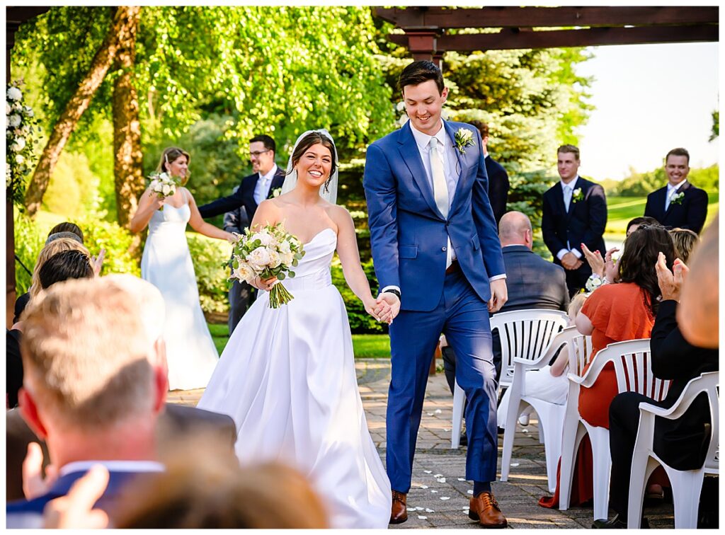 bride and groom walk down aisle Atkinson country club ceremony