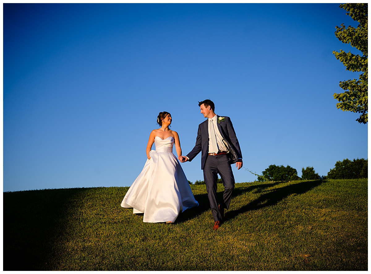 bride and groom walking down hill