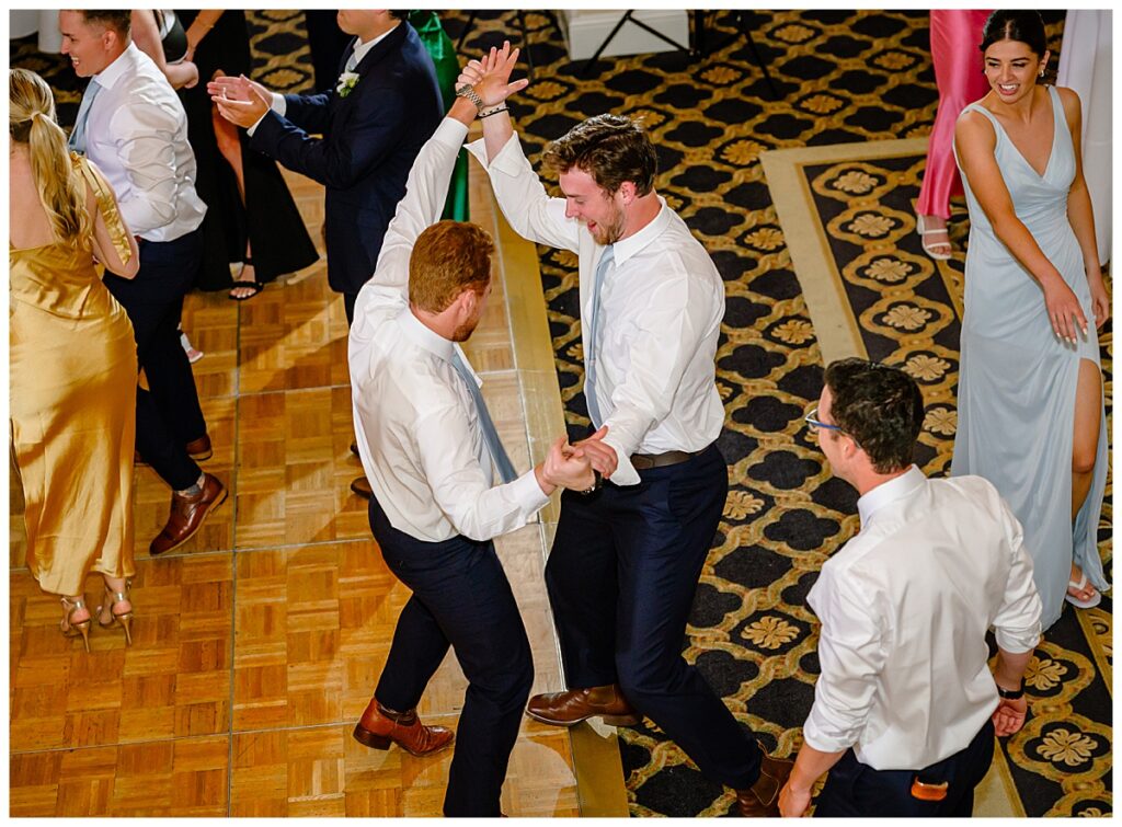 groomsmen dancing at reception at Atkinson country club