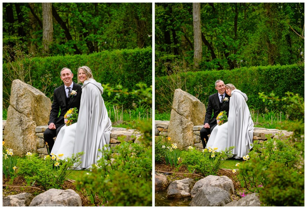 bride and groom sitting on a wall in the Sagamore Inn's gardens