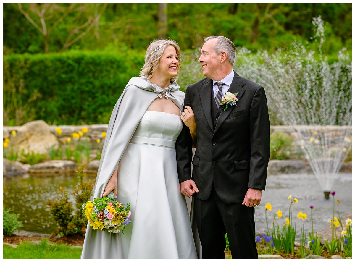 Bride and Groom looking at each other in gardens
