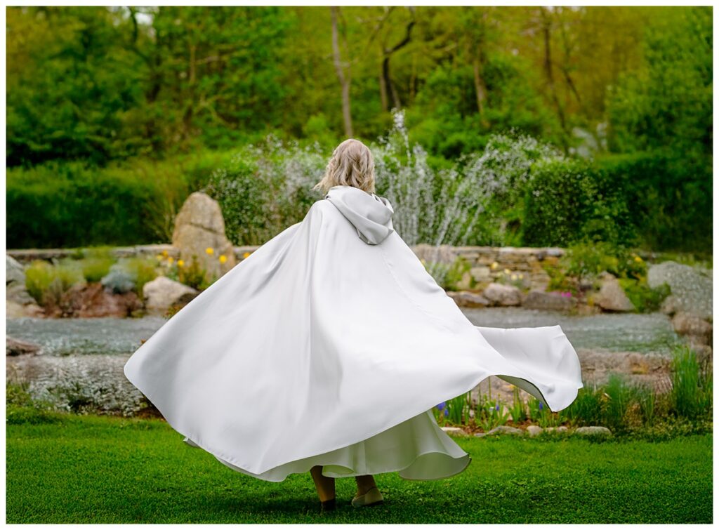 bride twirling in custom silver cape after cape cod elopement