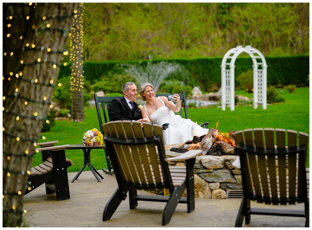 bride and groom snuggling by the fire and FaceTiming their parents