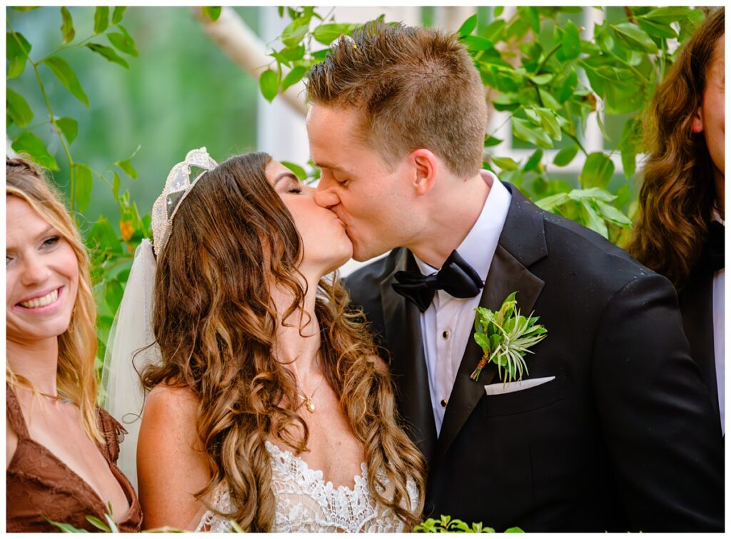 couple kisses barn on the pemi wedding greenhouse