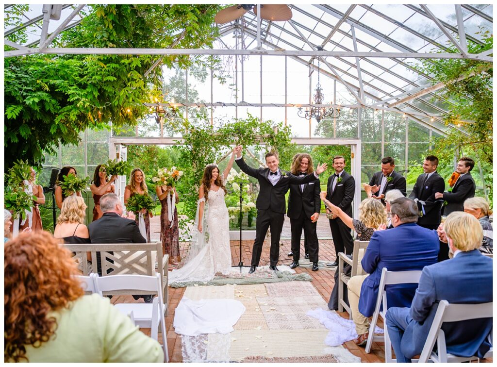 couple celebrating at barn on the pemi wedding ceremony greenhouse