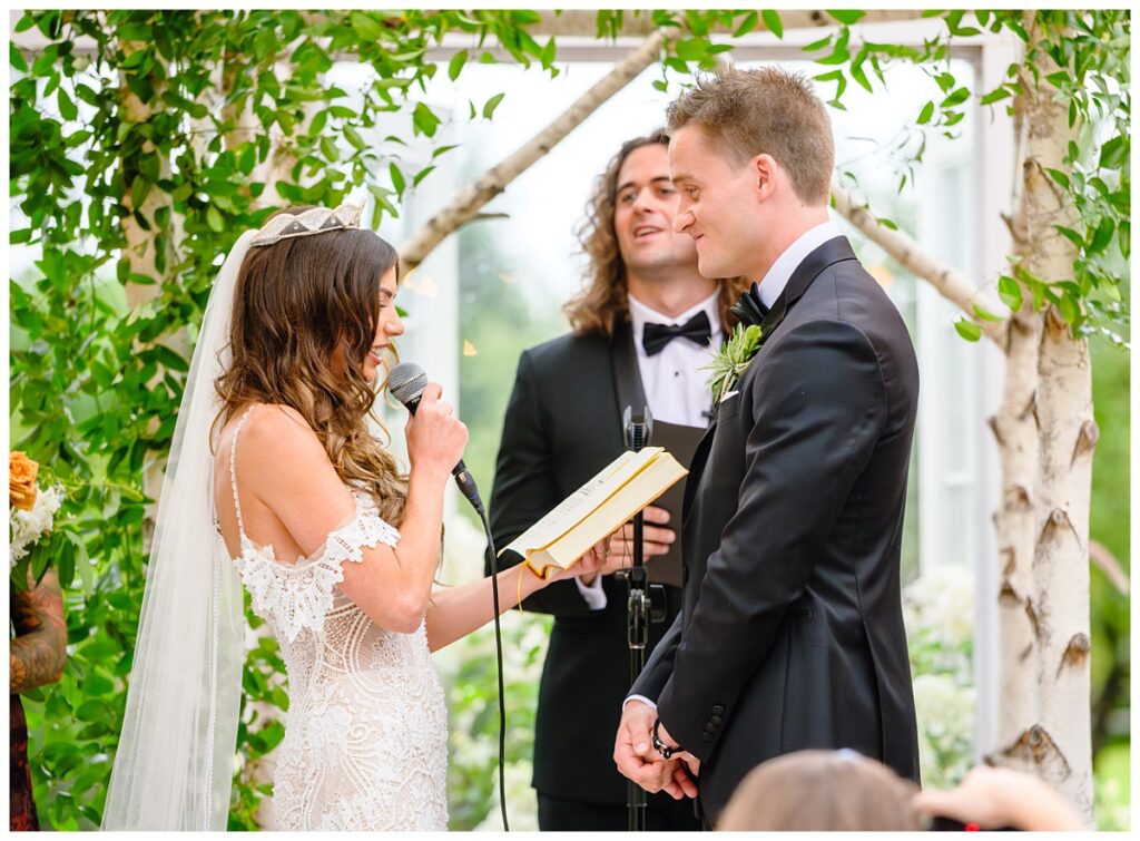 bride reads vows at barn on the pemi wedding ceremony greenhouse