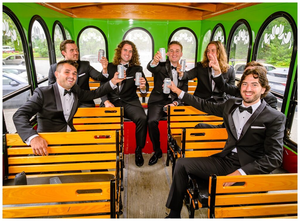 groomsmen on trolley to barn on pemi