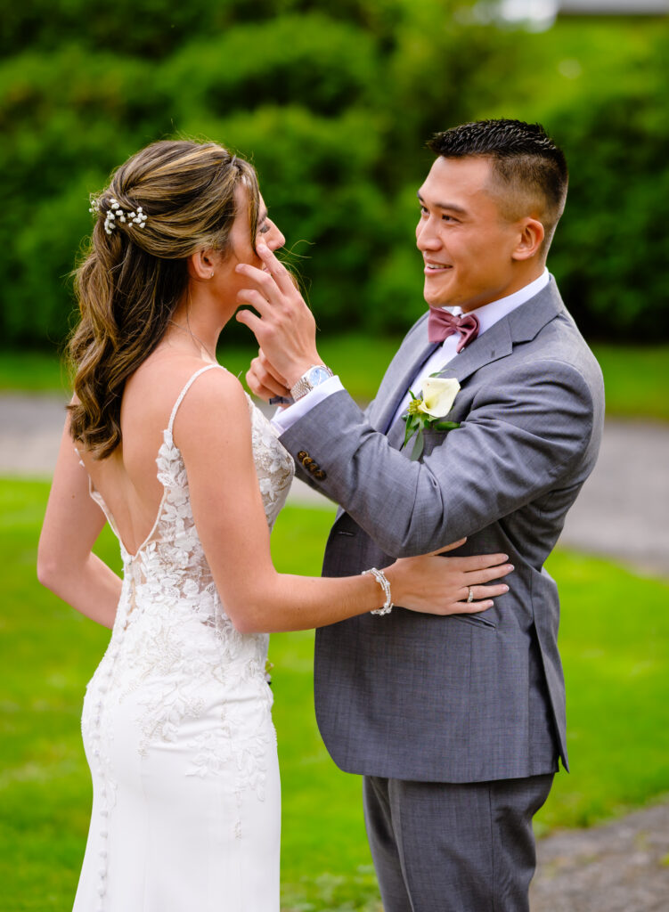 Couple wiping tears at first look before wedding ceremony at Harding Allen Estate in Barre MA