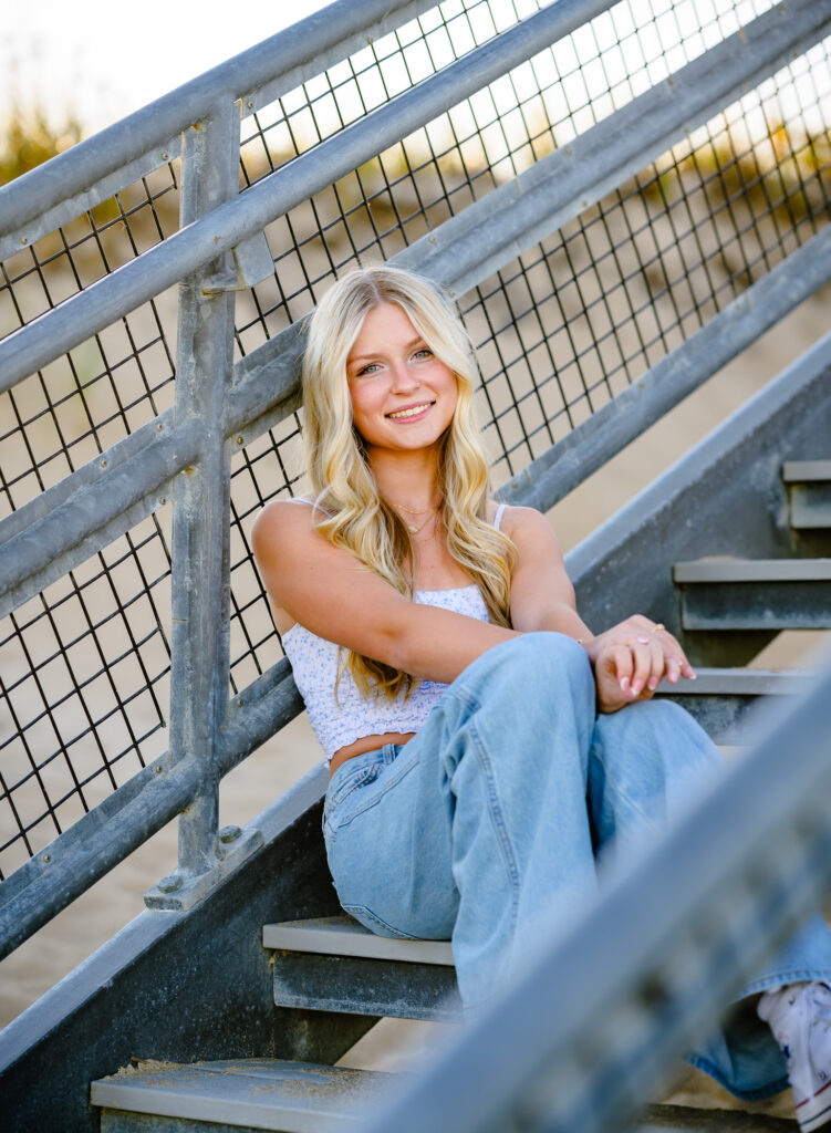 High school senior seated for Salisbury Beach Senior Portrait session by Jenn Plante Photography