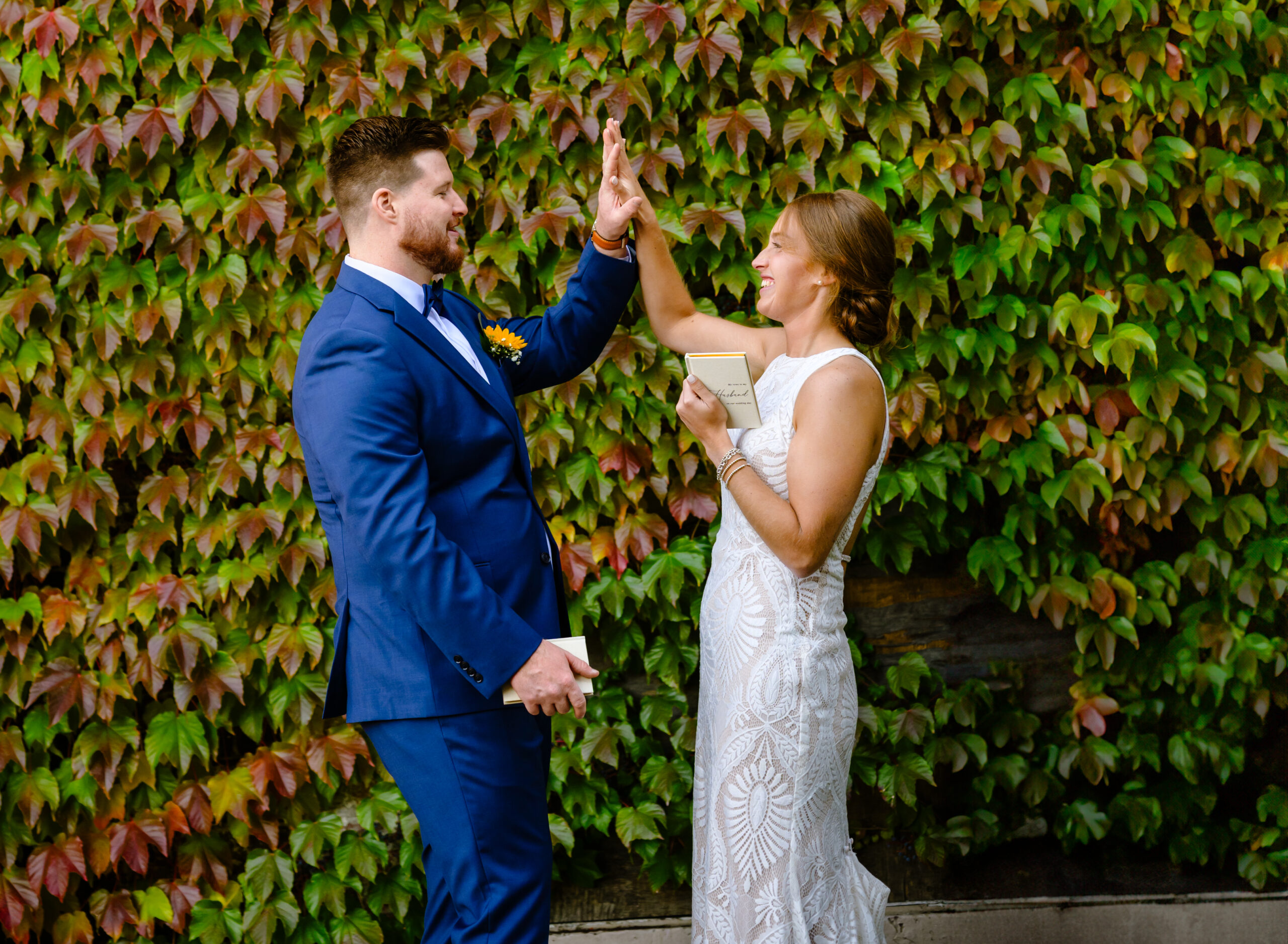 Couple high fives in first look before wedding ceremony at The Guild in Rhode Island